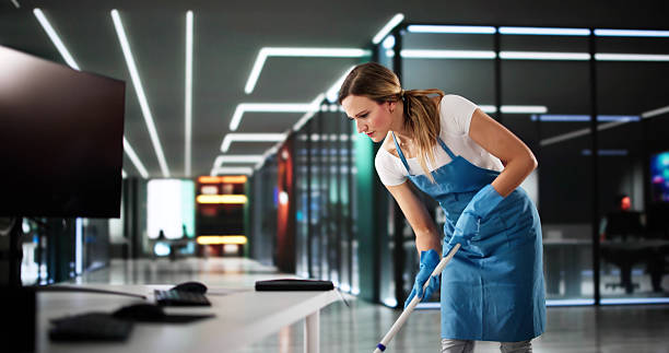 Expert commercial cleaning team sanitizing office workspace