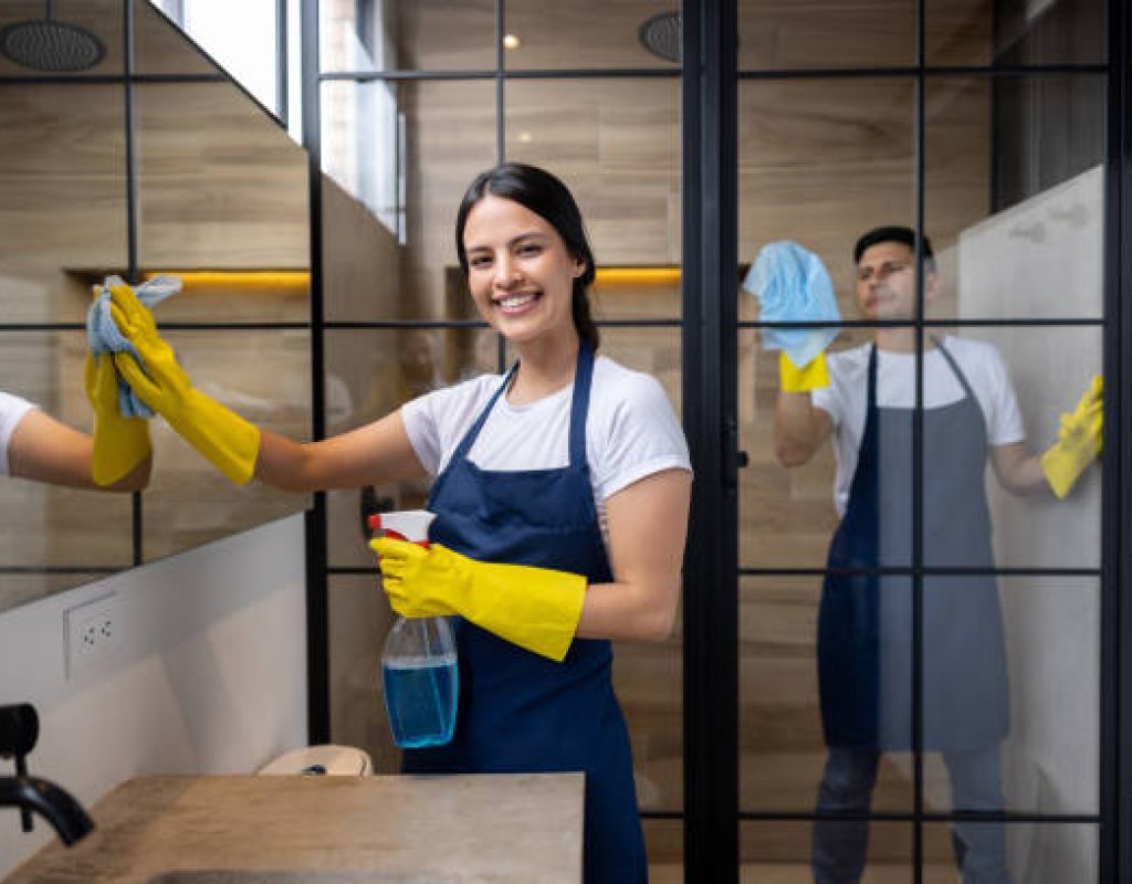 Recurring cleaning crew wiping counters and appliances for continuous home maintenance.